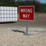 Short, red, "Wrong Way" sign embedded into the concrete testing area
